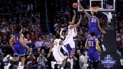 OKLAHOMA CITY, OKLAHOMA - MARCH 18: Dante Buford #21 of the Oklahoma Sooners goes up for a shot against Justin Hollins #33 and Brent Wrapp #1 of the Cal State Bakersfield Roadrunners in the first half in the first round of the 2016 NCAA Men's Basketball Tournament at Chesapeake Energy Arena on March 18, 2016 in Oklahoma City, Oklahoma. Ronald Martinez/Getty Images/AFP== FOR NEWSPAPERS, INTERNET, TELCOS & TELEVISION USE ONLY ==