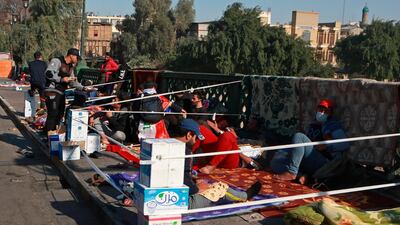 Protesters stage a sit-in on the Ahrar Bridge in Baghdad. AP Photo