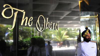 An attendant stands outside The Oberoi hotel's main entrance in Mumbai. Oberoi has a property in Dubai’s Business Bay that opened in June last year. Sajjad Hussain / AFP