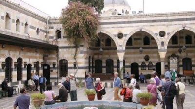 Tourists walk around Al-Azem Palace that houses the museum of arts and popular traditions in the Old City of Damascus, Syria. AP Photo/Ola Rifai