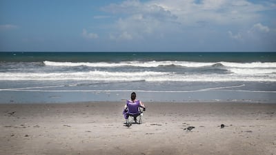 A beachgoer sits in a chair at Indialantic Beach on August 31, 2019 in Indialantic, Florida. Despite the holiday weekend, few people gathered at Indialantic Beach as the area hunkers down in preparation for Hurricane Dorian. Dorian, once expected to make landfall near Indialantic as a category 4 storm, is currently expected to turn north and stay off of the Florida coast, lessening the impact on the area. Scott Olson/Getty Images/AFP