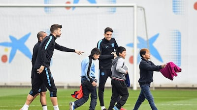 Young Barcelona fans ask for autographs after running on to the training pitch during a Barcelona training session ahead of the Uefa Champions League round of 16 second leg match between Barcelona and Arsenal at Ciutat Esportiva on March 15, 2016 in Barcelona, Spain. (Photo by David Ramos/Getty Images)