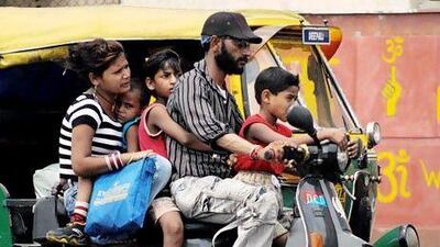 The family-on-a-scooter phenomenon still exists in India despite the advent of more affordable cars. Christophe Archambault / AFP