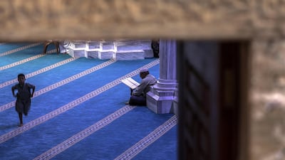 A Palestinian reads from the Quran at Al Omari mosque in Gaza City. EPA