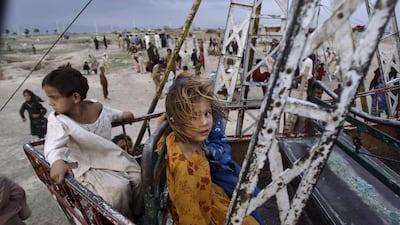 A Pakistani girl, who fled her village with her family from fighting between security forces and militants in Pakistan’s tribal area of Bajur, waits her turn at a makeshift entertainment park set up in a slum area.