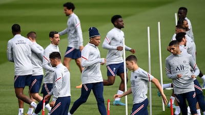 PSG's forward Kylian Mbappe, centre, training with teammates. AFP