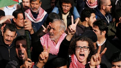 Demonstrators hold Jordanian national flag and chant slogans during a protest against a government's agreement to import natural gas from Israel, in Amman, Jordan. Reuters