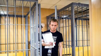 Ivan Golunov, a prominent Russian investigative reporter who worked for the independent website Meduza, leaves the cage in a court room in Moscow, Russia, after a ruling to place him under house arrest. AP