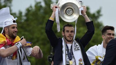 Real Madrid's Welsh forward Gareth Bale celebrates the team's win on Plaza Cibeles in Madrid on May 29, 2016 after the UEFA Champions League final foobtall match between Real Madrid CF, Club Atletico de Madrid held in Milan, Italy.