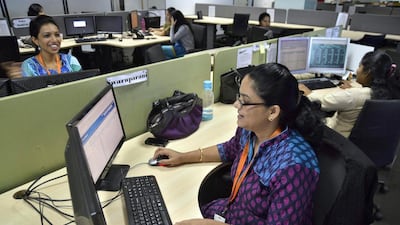 Employees of ISGN work at their stations inside the company headquarters in the southern Indian city of Bangalore. Reuters