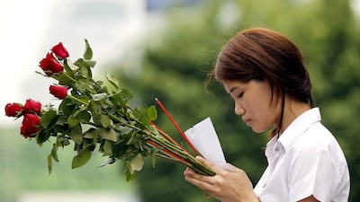 epa03105169 A Thai teenage girl prays with joss sticks and offering red roses to worship Trimurti Shrine, the god of love to mark Valentine's Day in Bangkok, Thailand, 14 February 2012. The Trimurti shrine, a God of love is dedicated to a trinity of Hindu Gods, Brahma, Vishnu and Siva. The shrine has also known as Lover's Shrine which Thai people believe that those who pray and make offering here for true love will have their dreams fulfilled. EPA/RUNGROJ YONGRIT *** Local Caption *** 03105169.jpg