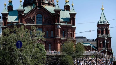 People watch as the US President Donald Trump arrives to meet Russian President Vladimir Putin at Finland's Presidential Palace in Helsinki on July 16, 2018. Brendan Smialowski / AFP