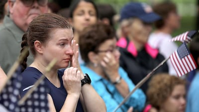 A woman wipes away tears following a wreath laying ceremony to honour the late Senator John McCain. Getty Images/AFP