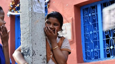Ganga Kalshetty, 12, smiles as she jokes outside of the leprosy colony.