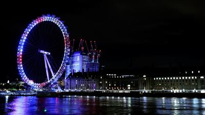 The London Eye is illuminated red, white and blue to show support for the The Duke and Duchess of Cambridge as they welcome their new baby son on April 23, 2018 in London, England. (John Phillips/Getty Images)