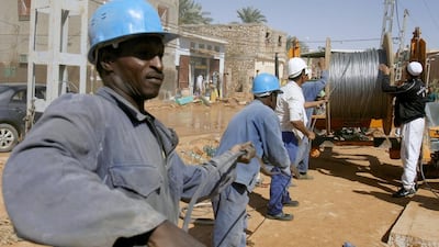 Workers pull an electric cable to restore power after heavy rains in the oasis town of Ghardaia in the M'Zab valley south of Algiers. Reuters