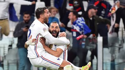 Theo Hernandez celebrates with Karim Benzema after scoring France's winning goal against Belgium in the Nations League semi-finals. Reuters