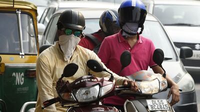 Motorcyclists cover their faces to protect against heavy smog in New Delhi on October 20, 2017, the day after millions of Indians celebrated the Diwali Festival by lighting firecrackers. Dominique Faget / AFP