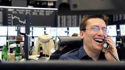 A stock broker laughs on the telephone at the stock exchange in the central German city of Frankfurt am Main on December 30, 2009. On the final day of trading of the year 2009 was at 5.957,43 points in comparison with 4.810,20 points on the same day last year.