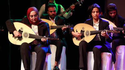 Iraqi musicians play oud during a concert at Al Rasheed theatre in Baghdad