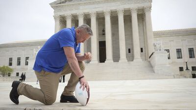 Former Bremerton High School assistant American football coach Joe Kennedy takes a knee in front of the US Supreme Court in April. AFP
