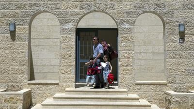 A Palestinian family leave their new apartment. About 250 families live in the city.