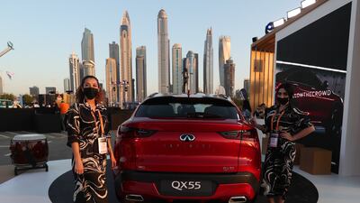 Models stand near A QX55 Infiniti. EPA
