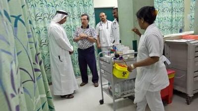 Doctors and nurses consult one another while tending to patients in the emergency centre of the Sheikh Khalifa Hospital in Ajman.