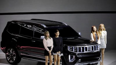 Members of K-pop idol group Black Pink pose for photographs with Kia Motors' Mohave. Reuters / Kim Hong-Ji