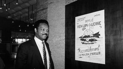 Jackson passes a poster reading ‘No to Reagan, to war’, in Strasbourg, where people were protesting against US President Ronald Reagan’s forthcoming appearance at the European Parliament, in May 1985. Jackson stood against Reagan unsuccessfully in 1984. AFP