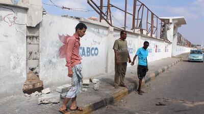 Yemenis stand at the site where a bomb attack killed five army recruits in the southern city of Aden on April 12, 2016. Saleh Al Obeidi / AFP