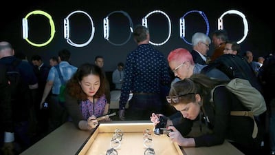 Attendees record a display of the new Apple Watch during an Apple special event at the Flint Center for the Performing Arts on September 9, 2014 in Cupertino, California. Apple unveiled the Apple Watch wearable tech and two new iPhones, the iPhone 6 and iPhone 6 Plus. Justin Sullivan / Getty Images / AFP