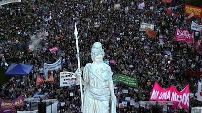 Thousands march past the Statue of Liberty in Buenos Aires as part of International Women's Day. AFP
