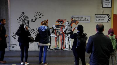 People look as others photograph a mural painted by the artist Banksy near the Barbican Centre in London, Britain, September 18, 2017. Reuters