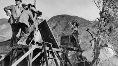 Mae Murray, right, and her husband, Robert Leonard, left, shoot a scene on location for Mademoiselle Midnight in 1924.