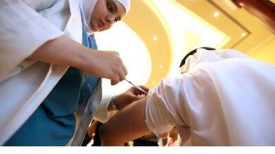 A nurse provides swine-flu vaccine in Abu Dhabi. Sammy Dallal / The National