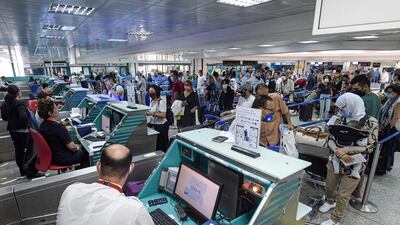 Passengers check-in their luggage before boarding departing flights at Tunis-Carthage International Airport in the Tunisian capital , as the North African country re-opens its land, sea, and air borders following a four-month closure due to the Covid-19 pandemic. AFP