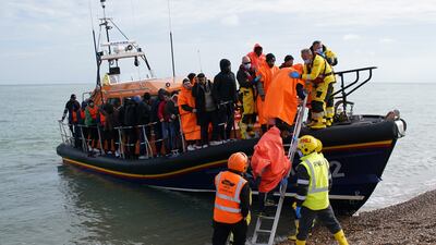 A group thought to be migrants are brought to Dungeness beach in Kent by lifeboat. PA