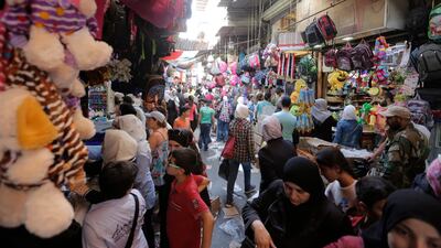 Syrians buy clothes and stationery for their children in one of the souks of the capital Damascus, one day ahead of the start of the new academic year. EPA