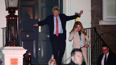 Britain's Prime Minister Boris Johnson and his girlfriend Carrie Symonds leave the Conservative Party's headquarters with their dog following the general election in London, Britain. Reuters