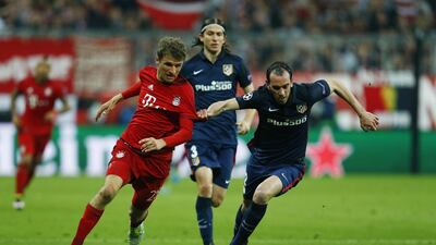 Atletico Madrid’s Diego Godin in action with Bayern Munich’s Thomas Muller. Ralph Orlowski / Reuters