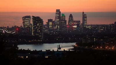 Lights illuminate skyscrapers as the sun sets in the City of London. The UK recently introduced a new tax law that means non-domiciles and non-residents who own property indirectly through corporate structures are liable for a UK death tax at 40 per cent. Bloomberg