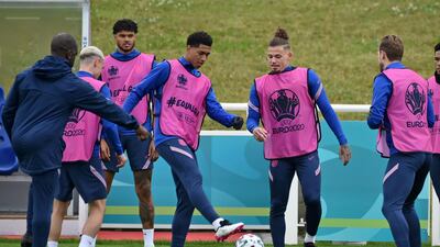 England's Jude Bellingham, centre, with the ball alongside Kalvin Phillips. AP