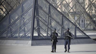 Police officers stand guard at the Pyramid of the Louvre Museum, near where soldiers shot a man who attacked them with a machete on February 3, 2017. Ian Langsdon / EPA