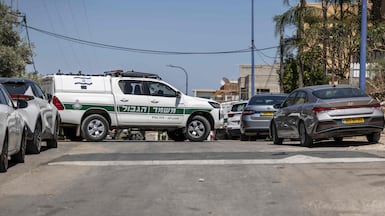 An Israeli border police vehicle blocks a street in the Arab city of Tayibe as security forces search the area following shootings in Israel. AFP