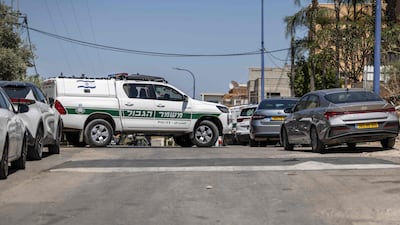 An Israeli border police vehicle blocks a street in the Arab city of Tayibe as security forces search the area following shootings in Israel. AFP