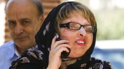 Ameneh Bahrami arrives at her home with her father in Tehran yesterday after pardoning her attacker. Raheb Homavandi / Reuters