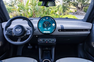 The highlight is an OLED circular centre screen, plus recycled textile trims in the dashboard and door panels. Photo: BMW