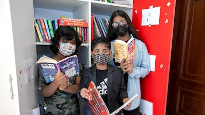 Ayaan with friends, Ayesha, 10, and Mohammad, 8, at his library.