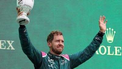 Aston Martin's German driver Sebastian Vettel celebrates on the podium after the Formula One Hungarian Grand Prix at the Hungarorin.